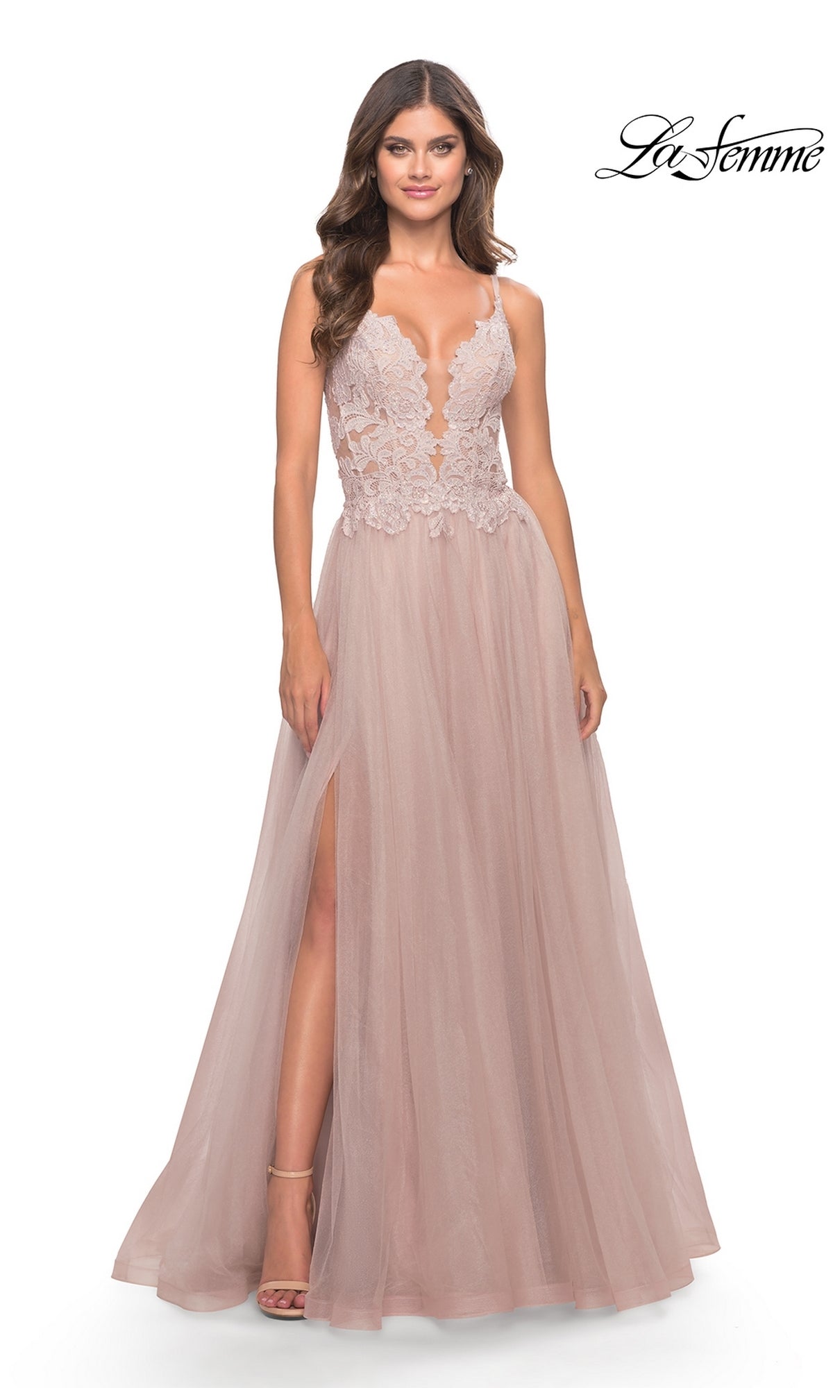 A woman wears the Lace-Bodice Long Tulle Prom Dress: La Femme 31507, featuring a sleeveless blush pink lace bodice, deep neckline, A-line tulle skirt, and thigh-high slit. The La Femme logo appears in the top right corner.